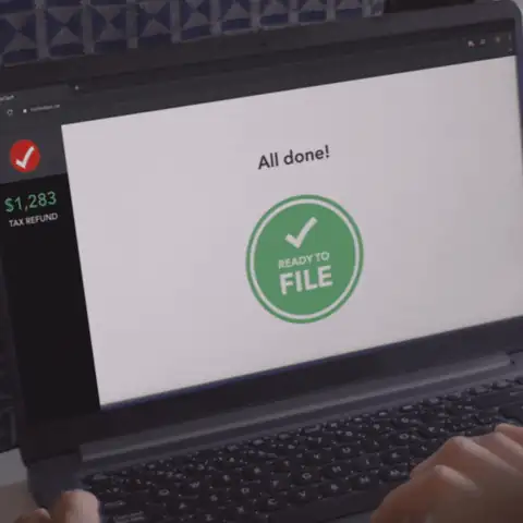 A laptop with a checkmark on the screen